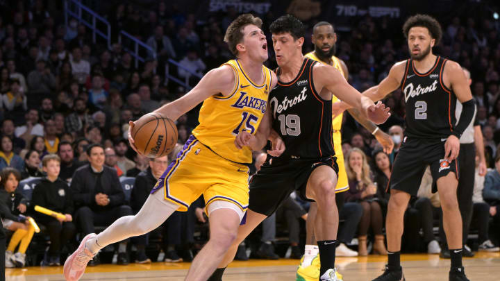 Feb 13, 2024; Los Angeles, California, USA;  Los Angeles Lakers guard Austin Reaves (15) is defended by Detroit Pistons forward Simone Fontecchio (19) in the first half at Crypto.com Arena. Mandatory Credit: Jayne Kamin-Oncea-USA TODAY Sports