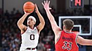 Feb 22, 2025; Spokane, Washington, USA; Gonzaga Bulldogs guard Ryan Nembhard (0) shoots the ball against St. Mary's Gaels forward Luke Barrett (33) in the first half at McCarthey Athletic Center. Mandatory Credit: James Snook-Imagn Images