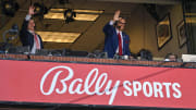 Bally Sports Midwest announcer Chip Caray and Brad Thompson wave to the fans during the second inning of an opening day game between the St. Louis Cardinals and the Toronto Blue Jays at Busch Stadium. 