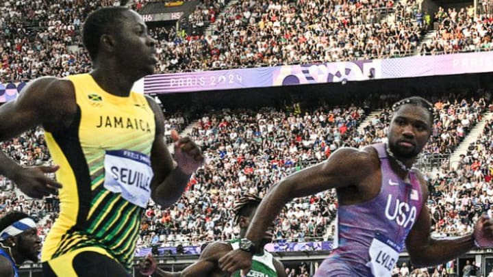 USA sprinter Noah Lyles and Jamaica's Oblique Seville stare at each other at the end of the men's 100m semifinal at the 2024 Paris Olympics on Sunday, August 4. 