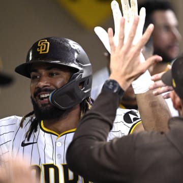 Jun 20, 2024; San Diego, California, USA; San Diego Padres right fielder Fernando Tatis Jr. (23) is congratulated in the dugout after hitting a home run against the Milwaukee Brewers during the fifth inning at Petco Park. Mandatory Credit: Orlando Ramirez-USA TODAY Sports