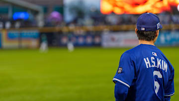 Mar 7, 2025; Peoria, Arizona, USA;  Los Angeles Dodgers infielder Hyeseong Kim (6) looks on during warm-ups for a spring training game between the Seattle Mariners at Peoria Sports Complex. Mandatory Credit: Allan Henry-Imagn Images