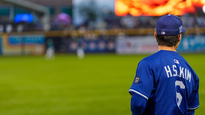 Mar 7, 2025; Peoria, Arizona, USA;  Los Angeles Dodgers infielder Hyeseong Kim (6) looks on during warm-ups for a spring training game between the Seattle Mariners at Peoria Sports Complex. Mandatory Credit: Allan Henry-Imagn Images