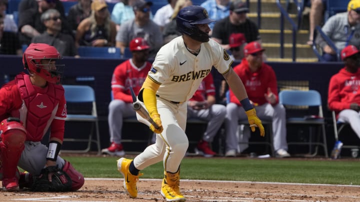 Mar 18, 2024; Phoenix, Arizona, USA; Milwaukee Brewers center fielder Garrett Mitchell (5) hits a single against the Los Angeles Angels in the first inning at American Family Fields of Phoenix. Mandatory Credit: Rick Scuteri-USA TODAY Sports