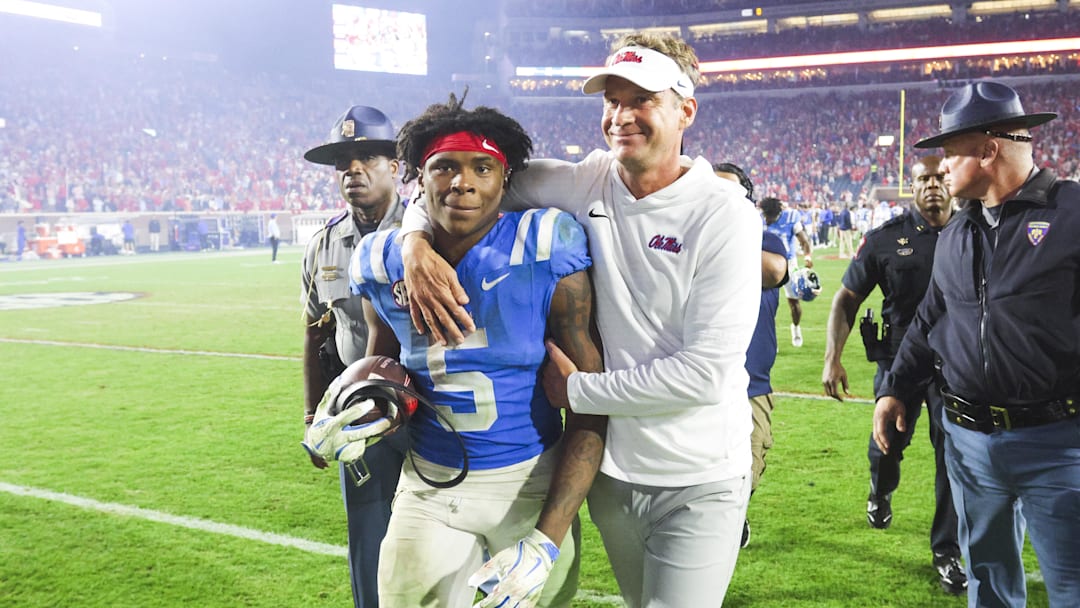 Nov 15, 2025; Oxford, Mississippi, USA; Mississippi Rebels head coach Lane Kiffin embraces running back Kewan Lacy (5) after defeating the Florida Gators at Vaught-Hemingway Stadium. Mandatory Credit: Petre Thomas-Imagn Images