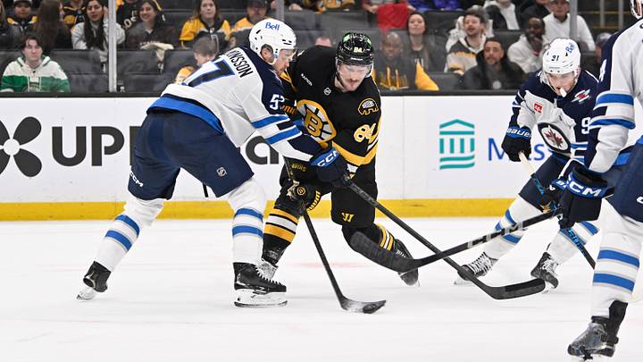 Mar 19, 2026; Boston, Massachusetts, USA; Boston Bruins left wing Tanner Jeannot (84) battles Winnipeg Jets defenseman Elias Salomonsson (57) to control the puck during the third period at TD Garden. Mandatory Credit: Eric Canha-Imagn Images Mar 19, 2026; Boston, Massachusetts, USA; Boston Bruins left wing Tanner Jeannot (84) battles Winnipeg Jets defenseman Elias Salomonsson (57) to control the puck during the third period at TD Garden. Mandatory Credit: Eric Canha-Imagn Images