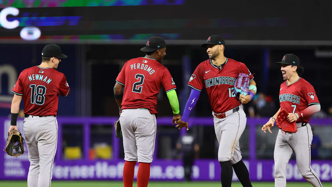 Aug 19, 2024; Miami, Florida, USA; Arizona Diamondbacks left fielder Lourdes Gurriel Jr. (12) celebrates with shortstop Geraldo Perdomo (2), second baseman Kevin Newman (18) and right fielder Corbin Carroll (7) after the game against the Miami Marlins at loanDepot Park. Mandatory Credit: Sam Navarro-Imagn Images