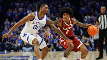 Jan 18, 2025; Lexington, Kentucky, USA; Alabama Crimson Tide guard Labaron Philon (0) dribbles the ball around Kentucky Wildcats guard Otega Oweh (00) during the first half at Rupp Arena at Central Bank Center. Mandatory Credit: Jordan Prather-Imagn Images