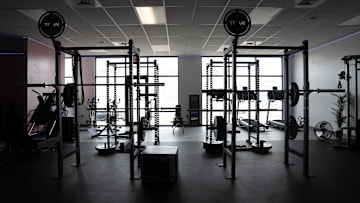 Weight-lifting racks and other exercise equipment are offered for members.