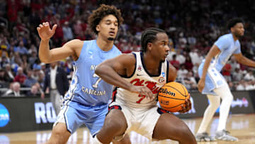 Mississippi Rebels guard Davon Barnes (7) keeps the ball from North Carolina Tar Heels guard Seth Trimble (7)