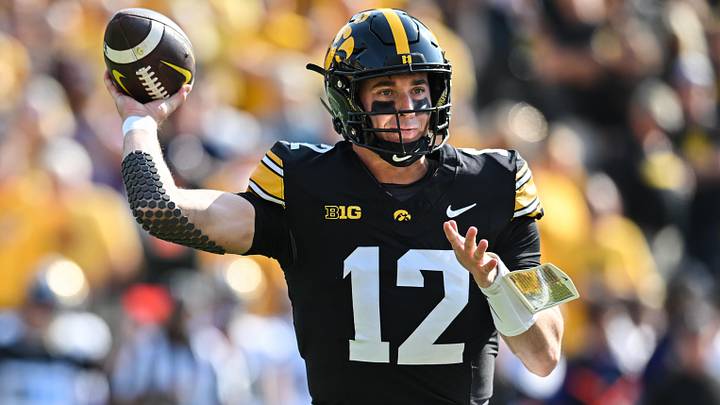 Oct 12, 2024; Iowa City, Iowa, USA; Iowa Hawkeyes quarterback Cade McNamara (12) throws a pass against the Washington Huskies during the first quarter at Kinnick Stadium. Mandatory Credit: Jeffrey Becker-Imagn Images