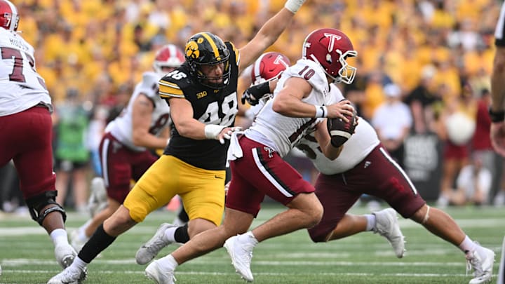 Sep 14, 2024; Iowa City, Iowa, USA; Iowa Hawkeyes defensive lineman Max Llewellyn (48) chases Troy Trojans quarterback Tucker Kilcrease (10) during the fourth quarter at Kinnick Stadium. Mandatory Credit: Jeffrey Becker-Imagn Images