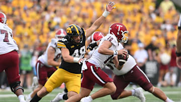 Sep 14, 2024; Iowa City, Iowa, USA; Iowa Hawkeyes defensive lineman Max Llewellyn (48) chases Troy Trojans quarterback Tucker Kilcrease (10) during the fourth quarter at Kinnick Stadium. Mandatory Credit: Jeffrey Becker-Imagn Images