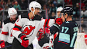 Jan 6, 2025; Seattle, Washington, USA; New Jersey Devils defenseman Jonas Siegenthaler (71) punches Seattle Kraken center Jaden Schwartz (17) during the third period at Climate Pledge Arena. Mandatory Credit: Steven Bisig-Imagn Images
