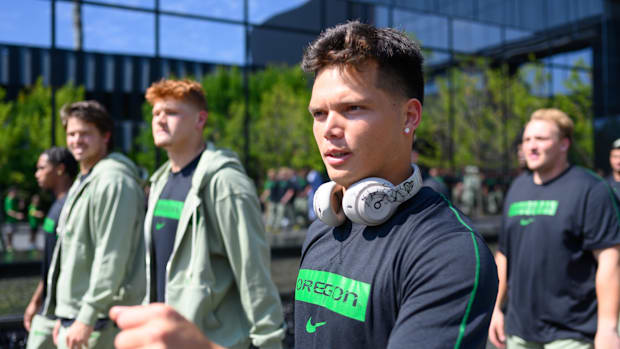 Oregon Ducks quarterback Dillon Gabriel (8) arrives with the team before the game