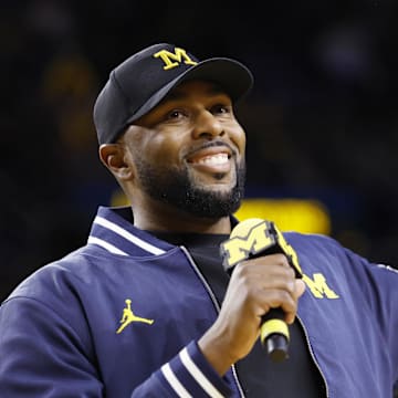 Jan 19, 2025; Ann Arbor, Michigan, USA;  Michigan Wolverines head football coach Sherrone Moore fires up the crowd in overtime of the basketball game against the Northwestern Wildcats at Crisler Center. Mandatory Credit: Rick Osentoski-Imagn Images
