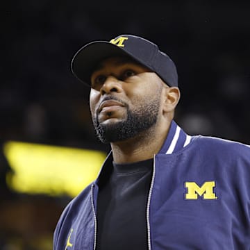 Jan 19, 2025; Ann Arbor, Michigan, USA;  Michigan Wolverines head football coach Sherrone Moore fires up the crowd in overtime of the basketball game against the Northwestern Wildcats at Crisler Center. Mandatory Credit: Rick Osentoski-Imagn Images