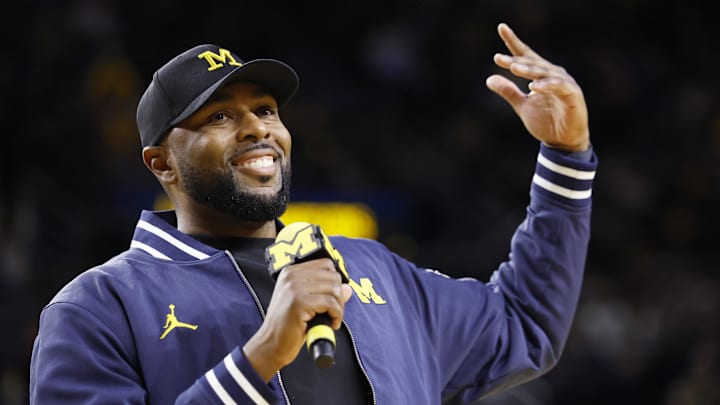 Jan 19, 2025; Ann Arbor, Michigan, USA;  Michigan Wolverines head football coach Sherrone Moore fires up the crowd in overtime of the basketball game against the Northwestern Wildcats at Crisler Center. Mandatory Credit: Rick Osentoski-Imagn Images