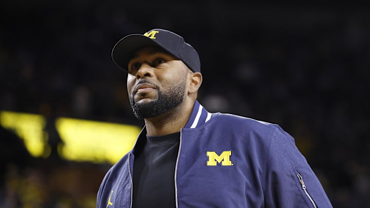 Jan 19, 2025; Ann Arbor, Michigan, USA;  Michigan Wolverines head football coach Sherrone Moore fires up the crowd in overtime of the basketball game against the Northwestern Wildcats at Crisler Center. Mandatory Credit: Rick Osentoski-Imagn Images