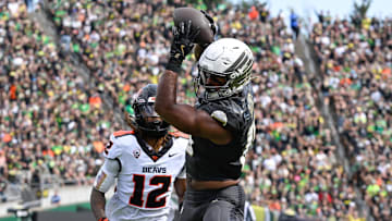 Sep 20, 2025; Eugene, Oregon, USA; Oregon Ducks tight end Kenyon Sadiq (18) makes a reception Oregon State Beavers defensive back Tyrice Ivy Jr. (12) of the game at Autzen Stadium. Sadiq scored a touchdown on the play. Mandatory Credit: Troy Wayrynen-Imagn Images