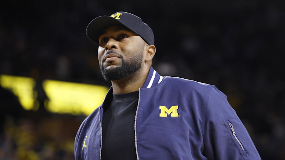 Michigan Wolverines head football coach Sherrone Moore looks on.