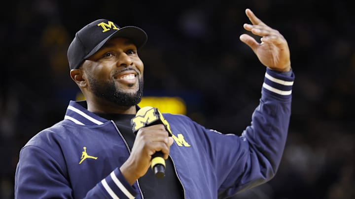 Jan 19, 2025; Ann Arbor, Michigan, USA;  Michigan Wolverines head football coach Sherrone Moore fires up the crowd in overtime of the basketball game against the Northwestern Wildcats.