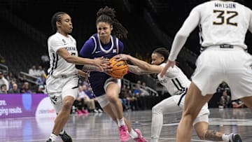 Mar 7, 2025; Kansas City, MO, USA; Kansas State Wildcats guard Zyanna Walker (1) drives to the basket while defended by West Virginia Mountaineers guard Sydney Shaw (5) and guard JJ Quinerly (11) in the third quarter at T-Mobile Center. Mandatory Credit: Amy Kontras-Imagn Images