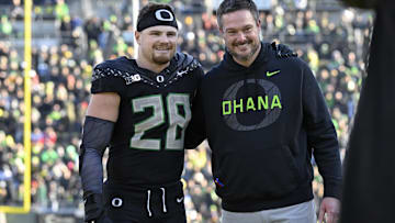 Nov 22, 2025; Eugene, Oregon, USA; Oregon Ducks linebacker Bryce Boettcher (28) poses for a photo head coach Dan Lanning before the game against the Southern California Trojans at Autzen Stadium. Mandatory Credit: Troy Wayrynen-Imagn Images