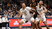 West Virginia University forward Amani Hansberry (13) and guard Javon Small (7) fight for the defensive rebound against Arizona State. 