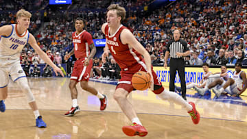 Mar 15, 2025; Nashville, TN, USA;  Alabama Crimson Tide forward Grant Nelson (4) drives to the basket against the Florida Gators during the first half at Bridgestone Arena. Mandatory Credit: Steve Roberts-Imagn Images