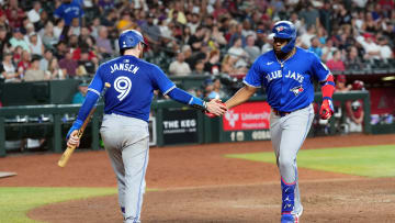 Jul 14, 2024; Phoenix, Arizona, USA; Toronto Blue Jays first base Vladimir Guerrero Jr. (27) slaps hands with Toronto Blue Jays catcher Danny Jansen (9) after hitting a solo home run against the Arizona Diamondbacks during the seventh inning at Chase Field.