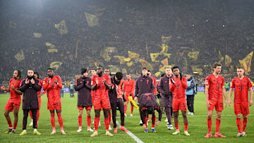 Bayern Munich players acknowledge the travelling away fans after the game