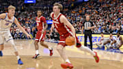 Mar 15, 2025; Nashville, TN, USA;  Alabama Crimson Tide forward Grant Nelson (4) drives to the basket against the Florida Gators during the first half at Bridgestone Arena. Mandatory Credit: Steve Roberts-Imagn Images