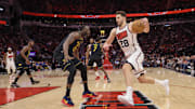 Houston Rockets center Alperen Sengun dribbles against Golden State Warriors forward Draymond Green.
