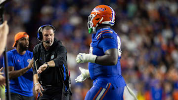 Nov 16, 2024; Gainesville, Florida, USA; Florida Gators head coach Billy Napier gestures towards Florida Gators defensive lineman Caleb Banks (88) against the LSU Tigers during the second half at Ben Hill Griffin Stadium. Mandatory Credit: Matt Pendleton-Imagn Images