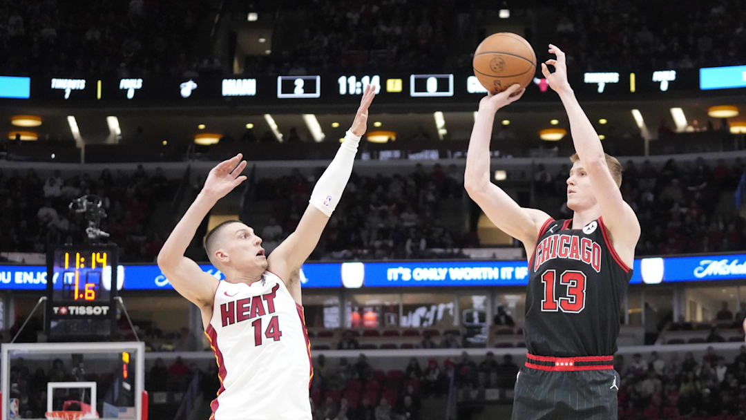 Apr 16, 2025; Chicago, Illinois, USA; Miami Heat guard Tyler Herro (14) defends Chicago Bulls guard Kevin Huerter (13) during the first quarter at United Center. Mandatory Credit: David Banks-Imagn Images 