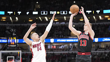 Apr 16, 2025; Chicago, Illinois, USA; Miami Heat guard Tyler Herro (14) defends Chicago Bulls guard Kevin Huerter (13) during the first quarter at United Center. Mandatory Credit: David Banks-Imagn Images 