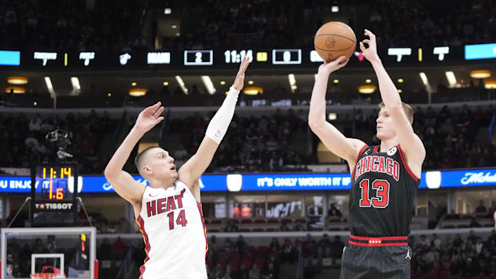 Apr 16, 2025; Chicago, Illinois, USA; Miami Heat guard Tyler Herro (14) defends Chicago Bulls guard Kevin Huerter (13) during the first quarter at United Center. Mandatory Credit: David Banks-Imagn Images 