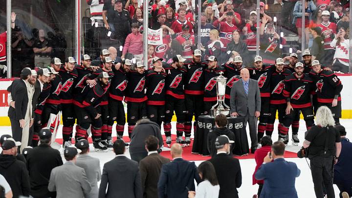 May 29, 2026; Raleigh, North Carolina, USA; The Carolina Hurricanes and NHL deputy commissioner Bill Daly pose for a photo with the Prince of Wales Trophy after Carolina defeated the Montreal Canadiens in game five of the Eastern Conference Final of the 2026 Stanley Cup Playoffs at Lenovo Center. Mandatory Credit: James Guillory-Imagn Images