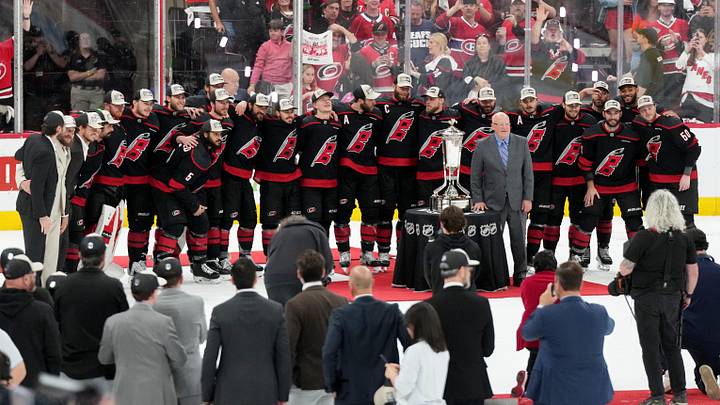 May 29, 2026; Raleigh, North Carolina, USA; The Carolina Hurricanes and NHL deputy commissioner Bill Daly pose for a photo with the Prince of Wales Trophy after Carolina defeated the Montreal Canadiens in game five of the Eastern Conference Final of the 2026 Stanley Cup Playoffs at Lenovo Center. 