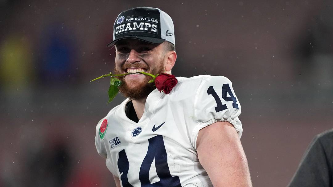 Jan 2, 2023; Pasadena, California, USA; Penn State Nittany Lions quarterback Sean Clifford (14) celebrates on the podium after the Penn State Nittany Lions defeated the Utah Utes in the 109th Rose Bowl game at the Rose Bowl. Mandatory Credit: Kirby Lee-Imagn Images