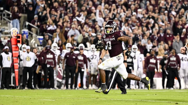 Nov 11, 2023; College Station, Texas, USA; Texas A&M Aggies wide receiver Ainias Smith (0) runs the ball to the end zone for a touchdown during the second half against the Mississippi State Bulldogs at Kyle Field. Mandatory Credit: Maria Lysaker-USA TODAY Sports