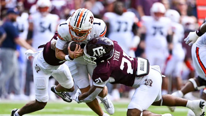 Sep 23, 2023; College Station, Texas, USA; Auburn Tigers quarterback Payton Thorne (1) is tackled by Texas A&M Aggies defensive back Bryce Anderson (1) and linebacker Taurean York (21) during the first quarter at Kyle Field. Mandatory Credit: Maria Lysaker-USA TODAY Sports