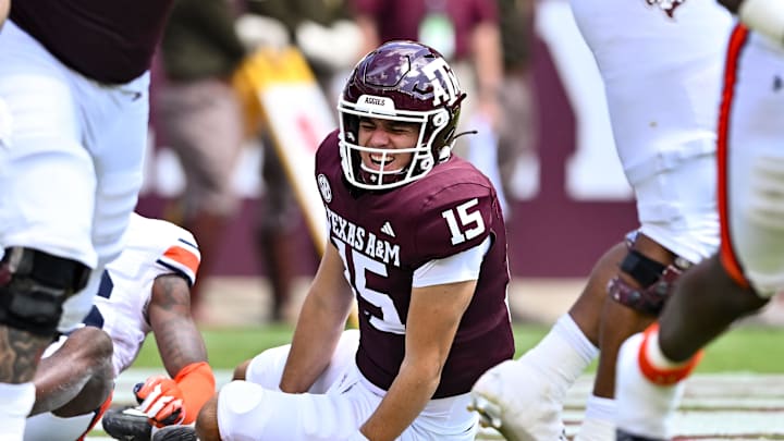 Sep 23, 2023; College Station, Texas, USA; Texas A&M Aggies quarterback Conner Weigman (15) treacts after getting hit during the second quarter against the Auburn Tigers at Kyle Field. Mandatory Credit: Maria Lysaker-Imagn Images