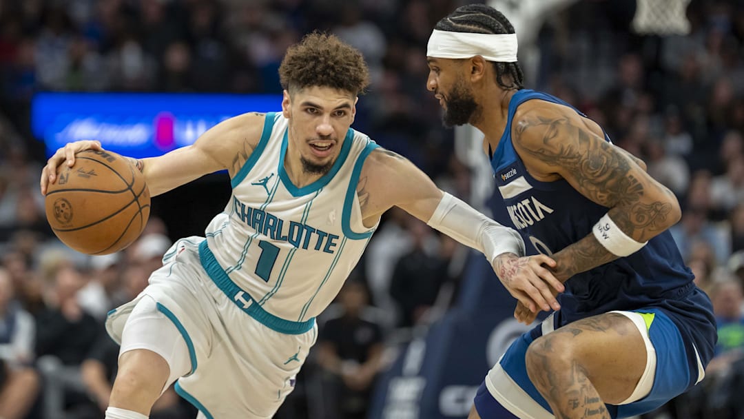Nov 4, 2024; Minneapolis, Minnesota, USA; Charlotte Hornets guard LaMelo Ball (1) drives to the basket past Minnesota Timberwolves guard Nickeil Alexander-Walker (9) in the second half at Target Center. Mandatory Credit: Jesse Johnson-Imagn Images