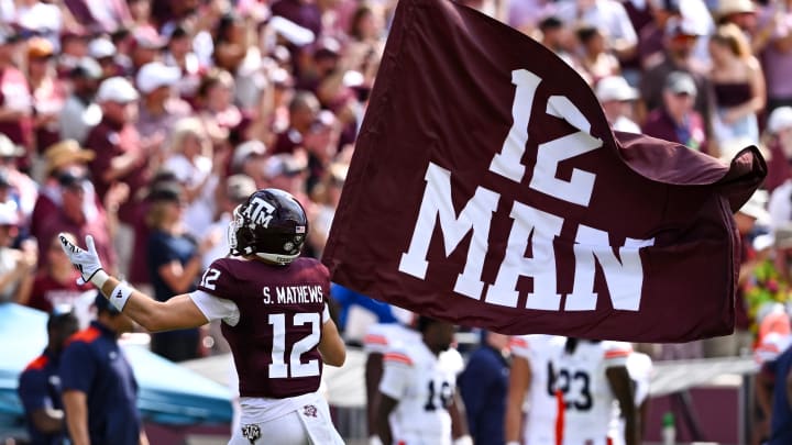 Sep 23, 2023; College Station, Texas, USA; Texas A&M Aggies linebacker Sam Mathews (12) waves the 12th Man flag during pre-game runout against the Auburn Tigers at Kyle Field. Mandatory Credit: Maria Lysaker-USA TODAY Sports