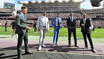 Sep 23, 2023; College Station, Texas, USA; SEC Nation crew speak on the sideline during pre-game between the Texas A&M Aggies and the Auburn Tigers; Marty Smith (far left, Tim Tebow (center left), Jordan Rodgers (center), Roman Harper (center right), Paul Finebaum (far right) at Kyle Field. Mandatory Credit: Maria Lysaker-Imagn Images
