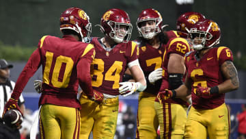 Dec 27, 2023; San Diego, CA, USA; USC Trojans wide receiver Kyron Hudson (10) celebrates with teammates after scoring a touchdown against the Louisville Cardinals during the first half at Petco Park. Mandatory Credit: Orlando Ramirez-USA TODAY Sports