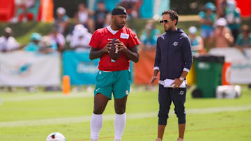 Miami Dolphins quarterback Tua Tagovailoa (1) talks to head coach Mike McDaniel during training camp at Baptist Health Training Complex.