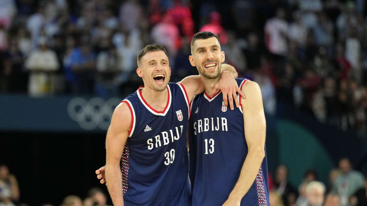 Aug 10, 2024; Paris, France; Serbia point guard Aleksa Avramovic (30) and shooting guard Ognjen Dobric (13) celebrate their win against Germany in the men's basketball bronze medal game during the Paris 2024 Olympic Summer Games at Accor Arena. Mandatory Credit: Kyle Terada-USA TODAY Sports